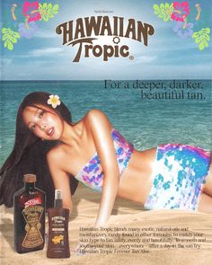 an advertisement for hawaiian tropic with a woman laying on the beach next to it