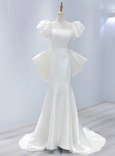 a white dress on display in a room