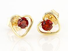 Pre-Owned .26ctw Round Vermelho Garnet™ Solitaire, Child's 10k Yellow Gold Heart Stud Earrings. Measure approximately .23"L x .25"W. Push backs..  This product may be a customer return, vendor sample, or on-air display and is not in its originally manufactured condition.  It may not be new.  In some instances, these items are repackaged by JTV. Gold Heart Stud Earrings, Gold Heart Studs, Heart Stud Earrings, Broken Chain, Pearl Strands, Heart Studs, Garnet Gemstone, Heart Earrings Studs, Red Garnet