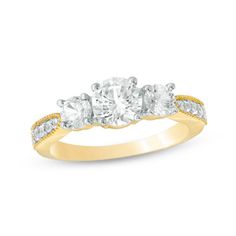 three stone diamond ring in yellow gold with diamonds on the band and side stones around the band