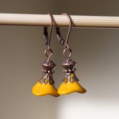 "Yellow Mustard Earrings Flower Earrings Jewelry Dangle earrings Drop Earrings Copper Earrings Czech Glass Earrings Gift For her Gift ideas Color : Yellow Mustard 10mm x 12mm Opaque 3-Petal Czech Glass Bell Flower Finish : Antiqued Copper Length: 1\"1/4 inches including the antiqued Copper lever back Ear wires : Antiqued Copper lever back Longer version : https://www.etsy.com/listing/249322981/yellow-mustard-earrings-copper-earrings?ref=shop_home_active_1 Available in,yellow mustard, peach, gree Yellow Flower Earrings With Round Beads, Yellow Beaded Czech Glass Earrings, Yellow Beaded Earrings With Czech Glass, Yellow Beaded Earrings In Czech Glass, Handmade Yellow Beaded Earrings With Czech Glass, Yellow Czech Glass Dangle Earrings, Yellow Flower Drop Earrings With Ear Wire, Yellow Czech Glass Beaded Dangle Earrings, Yellow Czech Glass Round Bead Earrings