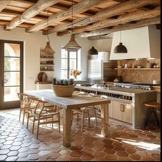 a large kitchen with an island table and chairs in the center, surrounded by wooden beams