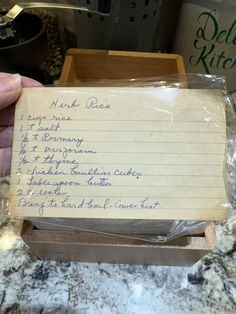 a note sitting on top of a counter next to a wooden box filled with writing