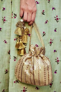 "If \"classic\" was a colour, it would be antique gold! With intricate embroidery on the gold net and tissue, embellished with edgy sequins and the tassel detailing is just the icing on the cake! Our antique gold potli will be your go-to-accessory with every outfit you own! Colour: Antique gold Embroidered front and back. Dimensions (LxB): 8.5\"--9\" Handle drop: 5\" (13 cm) Material : Embroidered net, gold tissue, poly satin lining, woven gold thread drawstrings, silk crochet tassle detailing." Silk Crochet, Potli Bag, Ethnic Bag, Potli Bags, Fancy Bags, Tassel Bag, Vintage Purses, Crafts Hacks, Indo Western