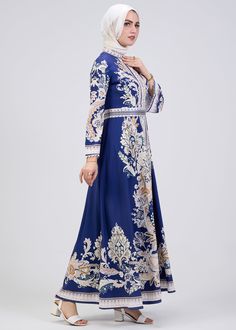 Step into timeless elegance with our Royal Blue Floral Print Satin Modest Dress, designed to elevate your wardrobe for every season. This modest dress features a luxurious satin fabric that drapes beautifully while offering comfort and sophistication. The intricate floral pattern in soft hues enhances the royal blue background, creating a striking yet graceful look. With its high neck and long kimono sleeves, this modest dress exudes a sense of classic charm. The empire waistline, accentuated wi Elegant Floral Print Maxi Dress For Eid, Elegant Blue Maxi Dress For Eid, Blue Long Dress For Eid, Long Sleeve Satin Dress For Eid, Eid Long Sleeve Satin Dress, Blue Floral Print Dress For Banquet, Royal Blue Dresses For Eid, Blue Fitted Maxi Dress For Eid, Fitted Blue Maxi Dress For Eid