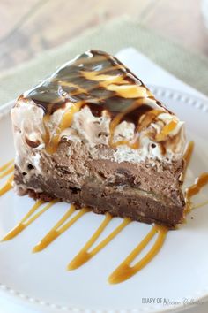 a piece of cake on a white plate with caramel drizzle and chocolate