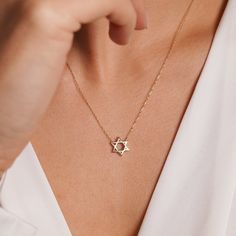 This stunning collection of Star of David Gold Necklaces is a true testament to faith and beauty, meticulously crafted in either 14K solid gold or 10K gold. The Elegant 14K Gold Star of David Necklace is a unique and meaningful gift choice for Mother's Day, exuding sophistication and sentimentality. For a more casual yet stylish option, the 10K Gold Everyday Jewish Necklace is perfect for everyday wear, making it an ideal gift for any occasion, especially for mothers who appreciate their Jewish Necklace For Mother, Jewish Necklace, Star Of David Necklace, Jewish Heritage, Solid Gold Necklace, Gold Necklaces, Star Of David, Gold Star, Trendy Jewelry