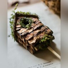 a piece of food that is sitting on top of some kind of paper with toothpicks in it