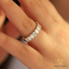 a woman's hand with a diamond ring on top of her finger, showing the band