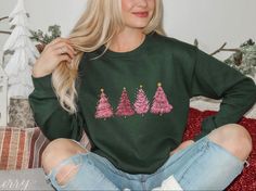 Festive Tree Picking Sweater: Comfy Crewneck perfect for Christmas Party or Gift! Size up 2 sizes for oversized look! Product Description:The Pink Christmas Tree Crewneck is the perfect sweater to add some festive flair to your holiday wardrobe. Featuring a vibrant pink color and a classic crewneck style, this sweater is both stylish and comfortable. The front of the sweater showcases a charming Christmas tree design, complete with colorful ornaments and a sparkling star on top. Made from high-q Festive Long Sleeve Fall Sweatshirt, Casual Winter Party Sweatshirt, Festive Long Sleeve Christmas Sweater, Casual Festive Sweatshirt For Fall, Casual Fall Festive Sweatshirt, Festive Holiday Crew Neck Sweater, Winter Party Crew Neck Sweatshirt, Festive Holiday Sweater With Crew Neck, Winter Party Sweatshirt With Crew Neck