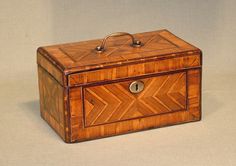 an old wooden box with a handle on the top and two drawers at the bottom