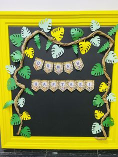 a yellow frame decorated with paper and leaves