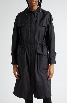 Crafted from water-repellent compact nylon, this hooded raincoat is a melding of modern functionality with a silhouette inspired by '70s workwear. Front zip closure with snap storm placket Lined drawcord-toggle hem Adjustable button-tab cuffs Front snap-flap patch pockets Storm flap Internal drawcord waist Water-repellent 100% nylon Machine wash, dry flat Imported Luxury Windproof Nylon Raincoat, Functional Nylon Moisture-wicking Outerwear, Long Parka Jacket, Technical Nylon Outerwear With Moisture-wicking, Streetwear Nylon Raincoat With Double-lined Hood, Toggle Coat, Long-sleeved Nylon Raincoat With Storm Flap, Long Parka, Long Puffer Coat