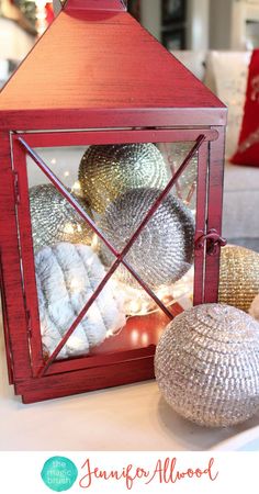 a red lantern sitting on top of a table next to a white and silver ball