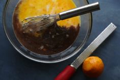 an orange and other ingredients in a glass bowl