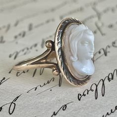 "Beautiful antique 10k gold carved shell cameo ring. The centerpiece of the ring is the show stopping carved shell cameo of a lady's profile in raised full relief. From each side of the ring you see the beautiful detailed profile of the lady. On the inside band it is the marking \"10k and \"KCS\" mark for the jeweler. This ring is a classic and timeless in style. Condition: Very Good Condition, The cameo and setting is intact, although the shell cameo moves in the setting but stays in setting se Art Deco Locket, Roman Goddess, Cameo Ring, Carved Shell, High Relief, Cameo Brooch, Ball Pendant, Unique Antiques, Oyster Shell