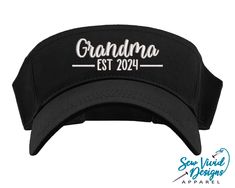 Save 15% off your first purchase by signing up at https://signup.sewvividdesigns.com This lightweight and comfortable visor features Grandma Est. 2024 (or your custom name/year) embroidered on your choice of visor.  Visor featured in photo: Black Text Color in photo: White 🧢 Visor Details 🧢 -One size fits most -Pre-curved visor -100% cotton -Hook and loop adjustable closure (Velcro) -Visor panel height 2.25" -Visor Bill length 2.75" Baseball Mom Hat, Custom Embroidered Hats, Mimi Gift, Nana Grandma, Distressed Baseball Cap, Mom Hats, New Grandma, Nana Gifts, Sport Hat