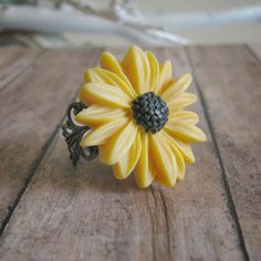 Sunflower Ring: Something boho chic for a Summer Festival, Matching sets for your beautiful bridesmaids on your summer wedding day, or just something fun to fit your vintage inspired wardrobe! This ring is the perfect fit to your needs.  This lovely sunflower ring is fully adjustable. The flower is attached using a high grade epoxy resin to ensure durability!  Each item in our shop is carefully handcrafted with love and attention to detail. Some items are delicate in nature and should be taken c Wedding Jewelry With Sunflower Design, Yellow Flower Ring For Wedding, Bohemian Flower Ring As A Gift, Bohemian Flower Ring For Promise, Yellow Flower Wedding Rings, Bohemian Flower Wedding Ring, Vintage Flower Ring For Wedding, Handmade Flower Shaped Ring For Wedding, Adjustable Yellow Flower Ring For Gift