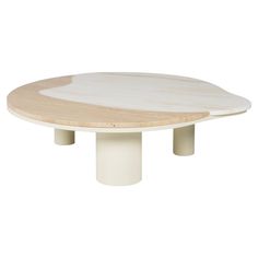 an oval table with two white pedestals on each side and a round wooden top