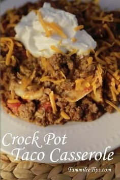 crock pot taco casserole on a plate with sour cream and cheese