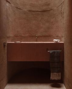 a bath room with a large tub and a sink under a skylight in the corner