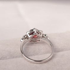 ◆The ring draws inspiration from the polaris. Hand-finished in Sterling sliver, this piece features a round shaped garnet . Clear zirzons decorate around the main stone. An extremely simple celestial ring that you cannot miss. ◆ Production Description: Main stone Type: Garnet Main Stone Shape: Round Main Stone Size:7*7mm(1.68ct) Side stone: CZ Metal: 925 Sterling silver - Other options available in the drop down menu ◆ Customization: √Free for Add Engraving √Other Metal Type Available √Other Gem Garnet Birthstone Cluster Ring, Garnet Cluster Ring As A Gift, Garnet Gemstone Cluster Ring, Silver Garnet Ruby Ring With Center Stone, Modern Ruby Birthstone Ring, Silver Ruby Ring With Diamond Bezel Setting, Silver Garnet Rings With Bezel Setting, July Birthstone Ring, Green Sapphire Ring