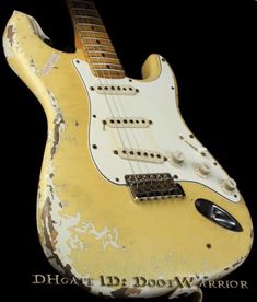 an old yellow and white electric guitar