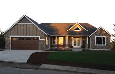 a large house with two garages on the front and one attached to the side