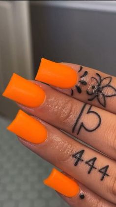 a person with orange nail polish on their nails and the numbers painted on her fingers