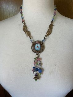 "OOAK Neo-Victorian Pastel Pendant Choker Necklace, Vintage Watch Face, Handmade Dangles This choker style Neo-Victorian necklace is so feminine with pretty pastel crystal beads, vintage stampings, as well as a pale blue vintage watch face inside a vintage filigree. All handmade. Closes with a large hook clasp in back. Chain 6\" Pendant 4\" Total length 13\" Many of my necklaces have chains that can be adjusted for length. Just message me and ask. If it's possible, I'm happy to do so. Oh, please Affordable Handmade Vintage Choker, Vintage Medallion Jewelry For Festival, Vintage Medallion Jewelry For Festivals, Vintage Festival Medallion Jewelry, Bohemian Medallion Necklace From Vintage Collection, Vintage Round Pendant Jewelry For Festivals, Vintage Festival Necklace With Vintage Charm, Festival Vintage Charm Metal Necklaces, Vintage Necklaces With Vintage Charm For Festival