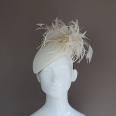 This lovely shape popular with The Duchess of Sussex is hand blocked in off white sinamay straw. Feathers in various shades of ivory and white add depths of colour as well as some height and movement to this lovely headpiece. Base measures 205mm x 175mm excluding trim. Attached with an easy to hide millinery elastic in a colour of your choice.  *One size fits all MADE TO ORDER - Please allow one week (2 weeks at busier times) However if you need your headpiece urgently please choose Next Day Del Cream Fitted Hat For Ceremony, Fitted Cream Hat For Ceremony, Fitted Cream Costume Hats And Headpieces For Ceremony, Cream Adjustable Costume Hats And Headpieces For Ceremony, Adjustable Cream Costume Hats And Headpieces For Ceremony, Adjustable Cream Costume Hat For Ceremony, Adjustable Cream Costume Hats For Ceremonies, Adjustable Beige Hats For Ceremony, Formal Cream Headpiece With Short Brim