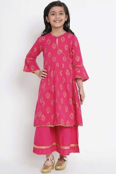 Buy Girl's Fuchsia Pink And Gold-Coloured Printed Kurta With Palazzos Online Pink Palazzo Set With Gota Work And Straight Kurta, Pink Palazzo Set With Zari Work On Straight Kurta, Pink Anarkali Set With Printed Motifs For Festive Occasion, Festive Pink Anarkali Set With Printed Motifs, Festive Pink Sharara With Printed Motifs, Pink Anarkali Palazzo Set With Printed Motifs, Pink Long Sleeve Sets With Gota Work, Pink Sharara With Printed Motifs For Navratri, Pink Anarkali Block Print Palazzo Set