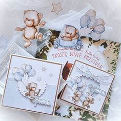 two cards with teddy bears on them and one has a baby's carriage in the background