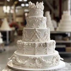 a large white wedding cake sitting on top of a table