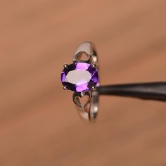 It is natural amethyst ring. The main stone is 7 mm*9 mm oval cut.weight about 1.77 carats.The basic metal is sterling silver and plated with rhodium.To change the metal to a solid gold (white/rose) or platinum is also available, please ask for a quotation if you want.You can also go to my shop Home for more elegant rings: https://www.etsy.com/shop/godjewelry?ref=hdr_shop_menu Amethyst is February birthstone More amethyst rings:https://www.etsy.com/shop/godjewelry?section_id=20709248Customizatio Oval Amethyst Promise Ring In White Gold, White Gold Amethyst Promise Ring With Oval Shape, Silver Heart Cut Amethyst Ring Fine Jewelry, White Gold Oval Amethyst Promise Ring, Oval White Gold Amethyst Promise Ring, Silver Solitaire Oval Amethyst Ring, Silver Oval Solitaire Amethyst Ring, Silver Oval Amethyst Birthstone Ring, Elegant Silver Heart Cut Amethyst Ring