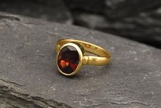 Gold Garnet Ring set with a Natural Garnet in a perfect diamond cut & a deep red color, at 10x8mm, 3 Carats, sourced from Mozambique. Red Antique Ring design made of Gold Vermeil ☞ thickest 18k Gold Plating on top of Solid 925 Sterling Silver ☞ made to last.☞ Choose your size ☞ I resize (before shipping) for FREE to Any size*Matching Earrings & Matching Pendant - please ask meJanuary Birthstone - Genuine & Natural Stones ❀⌛Last Ring left ⌛ ❀ Each Natural Gem is unique & will have Red Oval Hallmarked Birthstone Ring, Red Oval Birthstone Ring Hallmarked, Red Oval Ring With Bezel Setting, Red Oval Rings With Bezel Setting, Oval Faceted Ruby Ring For Anniversary, Oval Ring Gold, Solitaire Ring Oval, Gold Garnet Ring, Earrings Matching