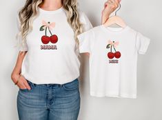 Matching t-shirt mom and daughter. Shirt with cherries and a bow. Summer T-shirt for all mothers with daughters. Dress in your partner look and enjoy the summer. The unisex soft-style t-shirt puts a new spin on casual comfort. This t-shirt is made from a very soft material and is 100% cotton in solid colors. Heather colors and sport gray contain polyester. The shoulders are twill taped for durability. There are no side seams. The collar is ribbed to prevent puckering. - Made from 100% ring-spun Matching Funny Print Summer Tops, Summer Matching Custom Print Tops, Summer Graphic Print Matching T-shirt, Matching Summer Cotton Tops, Summer Cotton Tops With Matching Style, Family Matching Funny Print Summer Tops, Family Summer T-shirt With Crew Neck, Family Matching Funny Print Tops For Summer, Family Matching Tops With Funny Print For Summer