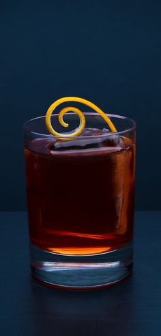 an orange slice sitting on top of a glass filled with liquid