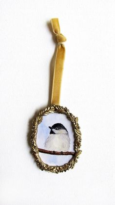 an ornament with a bird sitting on a branch