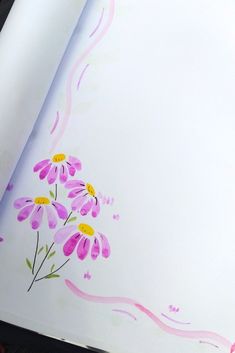 an open book with flowers painted on it