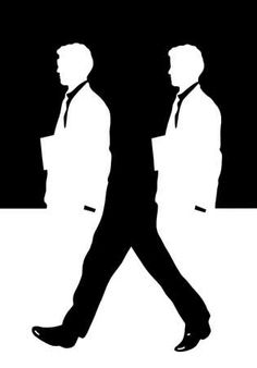 two men in suits walking down the street