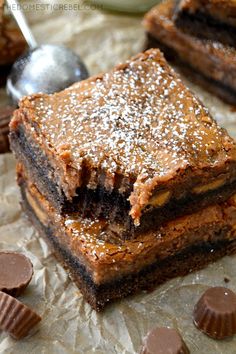 two pieces of dessert sitting on top of a piece of wax paper