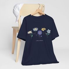 This Wildly Brilliant Wildflower Tshirt is a perfect summer t-shirt. The classic unisex jersey short-sleeve tee fits like a well-loved favorite. The cotton is soft to the touch, making it an ideal choice for comfort. The ribbed knit collars bolster the shape. The shoulders have taping for better fit over time. This shirt is true to size (see size chart - 6 available sizes: S, M, L, XL, 2XL, 3XL). It is available in 5 colors - white, natural, light blue, athletic gray, and navy.  Order this Wildl Floral Print Short Sleeve Cotton T-shirt, Blue Crew Neck T-shirt With Plant Print, Floral Print Cotton T-shirt With Short Sleeves, Spring Blue T-shirt With Floral Embroidery, Cotton Floral Print Short Sleeve T-shirt, Blue Relaxed Fit T-shirt With Plant Print, Blue Cotton T-shirt With Plant Print, Summer Birth Flower Short Sleeve T-shirt, Wildflower T Shirt