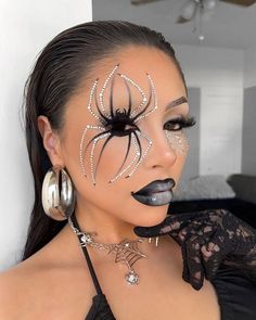 a woman with spider makeup on her face