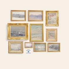 an assortment of framed paintings on the wall