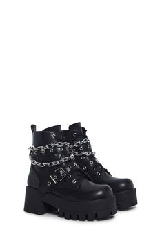 These boots have a vegan leather construction, treaded soles, buckle details, a removable silver chain link, front lace-ups, and side zipper closures. Edgy Lace-up Combat Boots With Buckle Closure, Chain Detail Boots With Round Toe For Streetwear, Chain Detailed Round Toe Boots For Streetwear, Chain Detail Round Toe Boots For Streetwear, Fall Chain Strap Boots With Round Toe, Fall Boots With Chain Strap And Round Toe, Trendy Chain Boots For Fall, Chain-decorated Round Toe Boots For Streetwear, Punk Style Chain Boots For Streetwear