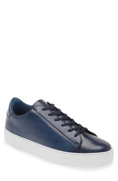 Polished leather elevates the look and feel of a streamlined sneaker that goes with everything and features a stretchy interior to keep every step secure. Lace-up style Removable insole Leather upper/synthetic lining/rubber sole Made in Portugal Blue Leather Casual Slip-on Sneakers, Casual Blue Leather Slip-on Sneakers, Navy Lace-up Leather Sneakers, Navy Leather Sneakers With Perforated Toe Box, Sporty Navy Sneakers With Leather Sole, Blue Leather Modern Sneakers, Blue Leather Slip-on Sneakers, Modern Blue Leather Sneakers, Blue Leather Sneakers With Perforated Toe Box