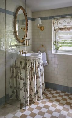 a bath room with a sink and a mirror on the wall next to a window