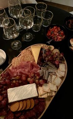 a table topped with lots of different types of food and glasses on top of it