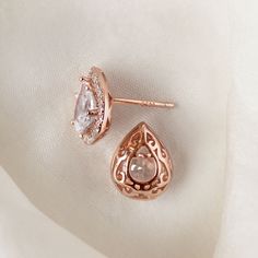 These classic Teardrop / Pear studs boast a spectacular halo of pave crystals that really give off its shine. Complete your bridal look with a sleek back bun to show off your standout style. Rose Gold Vermeil Cubic Zirconia pave crystals Hypoallergenic post Height: 0.5in (1.3cm) x Width: 0.39in (1cm) #E440 Rose Gold Bridal Earrings With Sparkling Stones For Anniversary, Rose Gold Sparkling Stones Bridal Earrings For Anniversary, Elegant Rose Gold Teardrop Earrings For Anniversary, Rose Gold Drop Bridal Earrings For Anniversary, Rose Gold Halo Earrings For Wedding, Rose Gold Halo Setting Earrings For Wedding, Rose Gold Teardrop Bridal Earrings For Anniversary, Rose Gold Teardrop Halo Jewelry, Sleek Back Bun